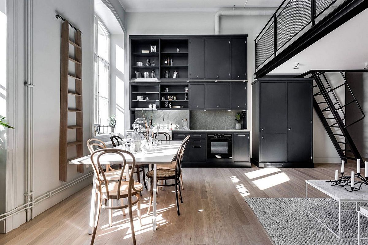 Double height kitchen and dining room of the small Scandinavian apartment in Stockholm