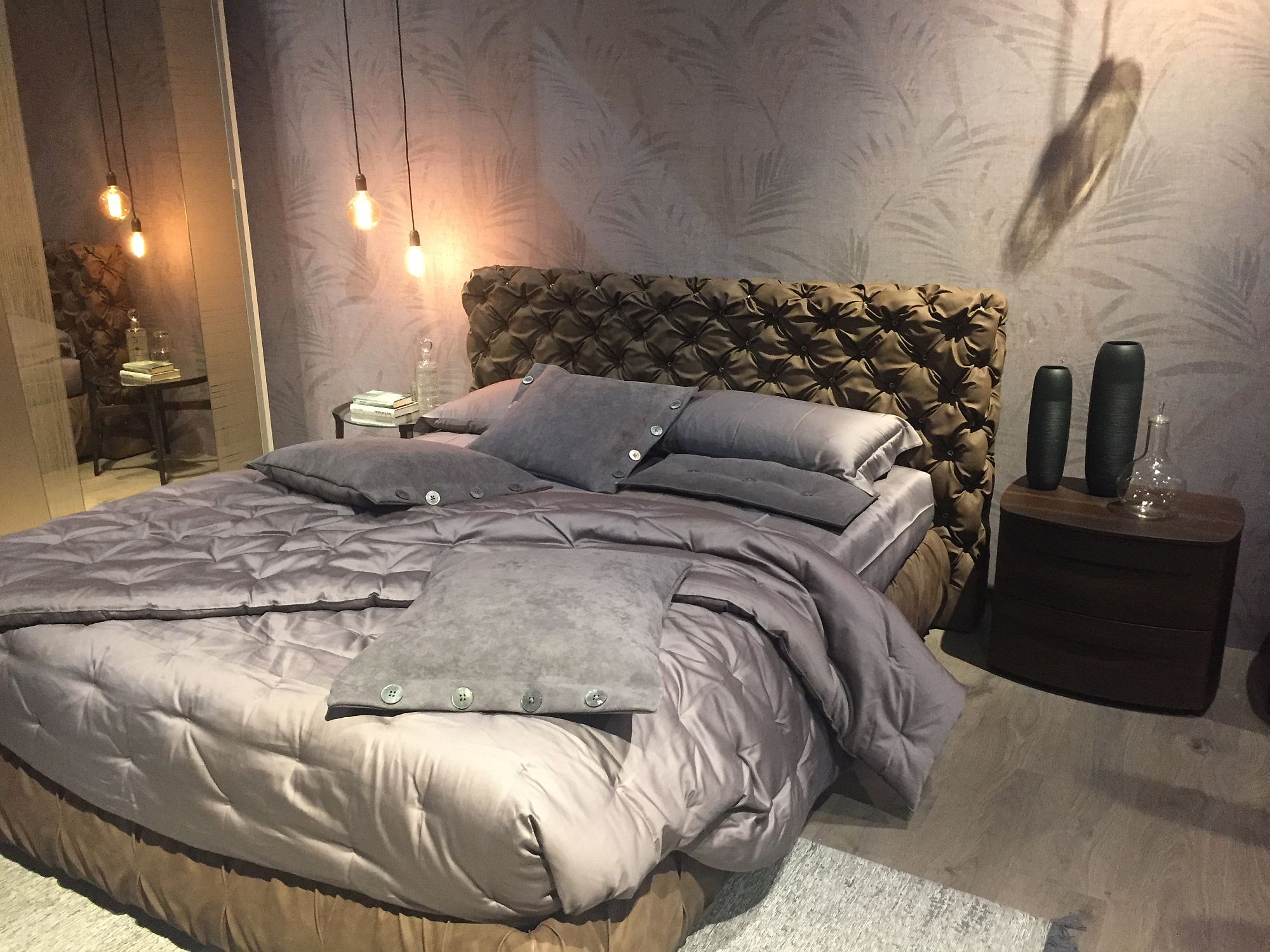 Gorgeous tufted headboard steals the show in this contemporary bedroom