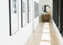 Modern hallway gallery with large black frame pictures.