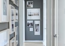 Hallway gallery with white framed pictures on the left wall and a few more on the end wall.
