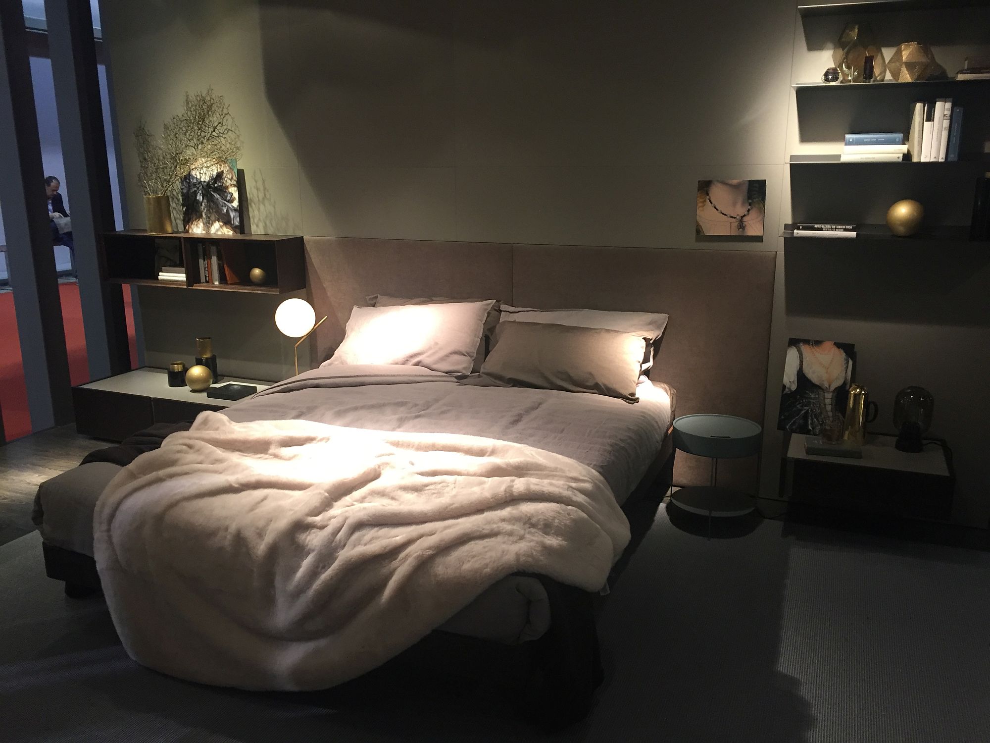 Headboard of the bed becomes one with the floating shelves and nightstands next to it