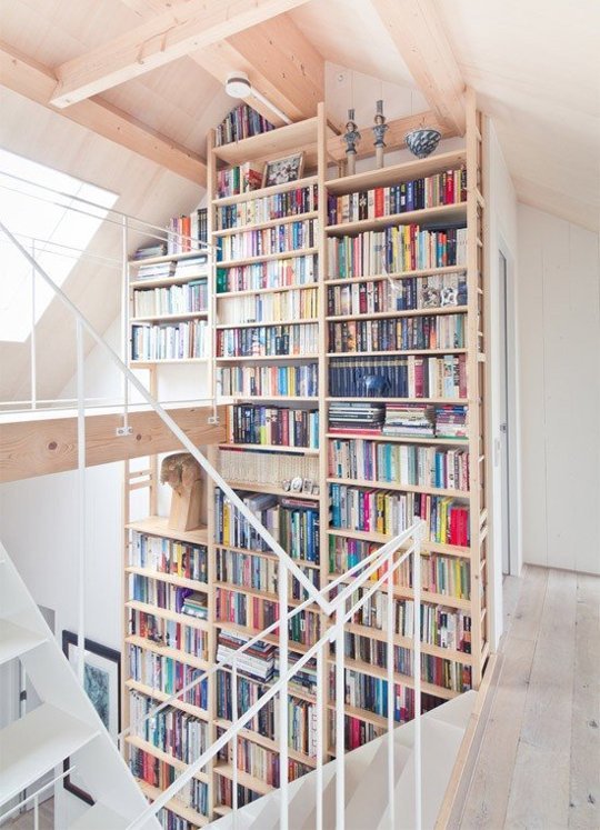 Staircase with built-in bookshelves offering access to many books.