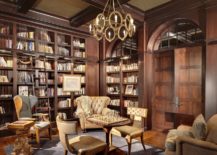 A massive wooden bookcase stands tall, adorned with countless books. Comfortable chairs are scattered around.