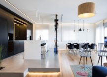 Kitchen-on-an-elevated-platform-with-cool-lighting-and-dark-cabinets-in-the-backdrop-217x155