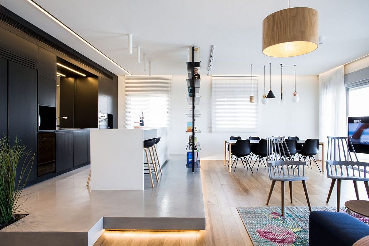 Kitchen on an elevated platform with cool lighting and dark cabinets in the backdrop