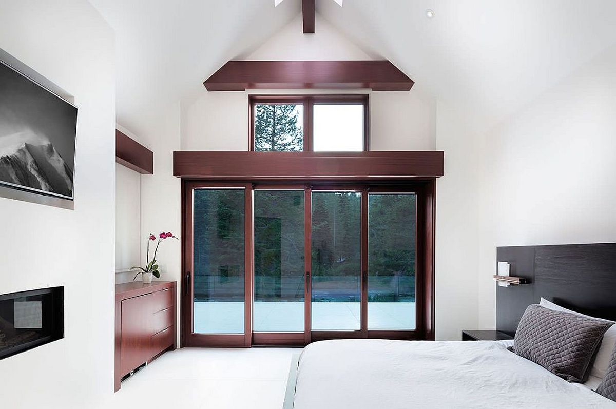 Large sliding doors connect the bedroom with the outdoors