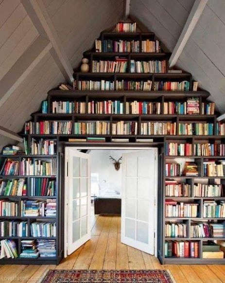 A-frame home with double doors surrounded by a full book shelf.