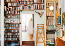 A cozy living room with bookshelves and a wooden ladder.