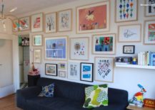 Living room gallery with a bright wall covered in framed art pieces.