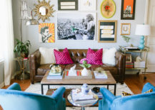 Colorful living room with a gallery that features a unique mirror, art pieces, and quotes.