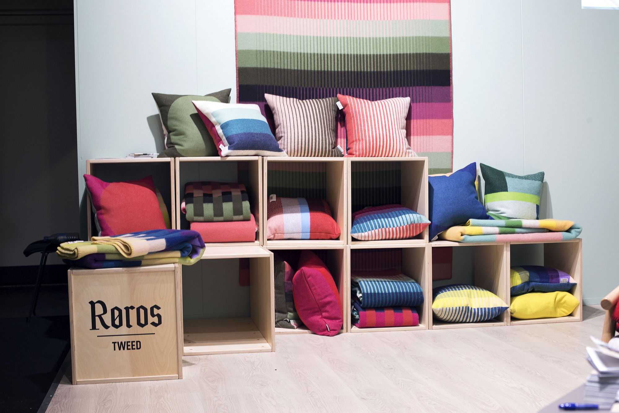 Luxurious and colorful textile display from Røros Tweed at IMM Cologne 2017