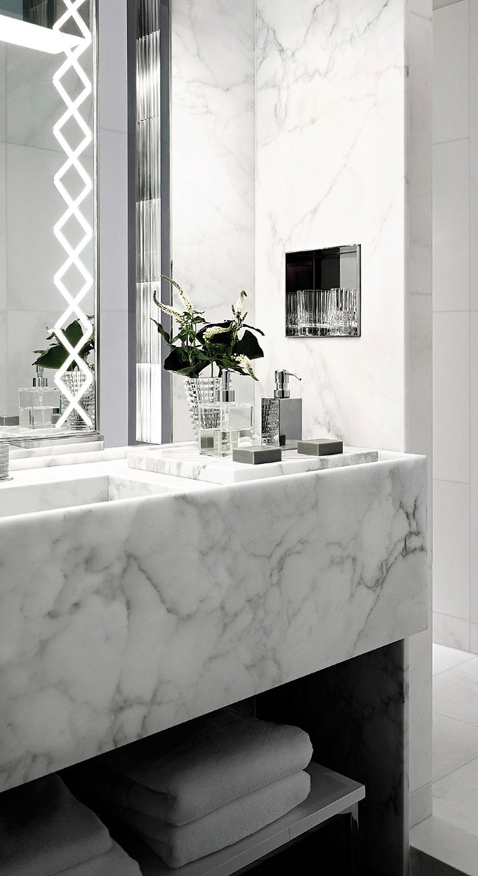 Marble bathroom with natural accents.