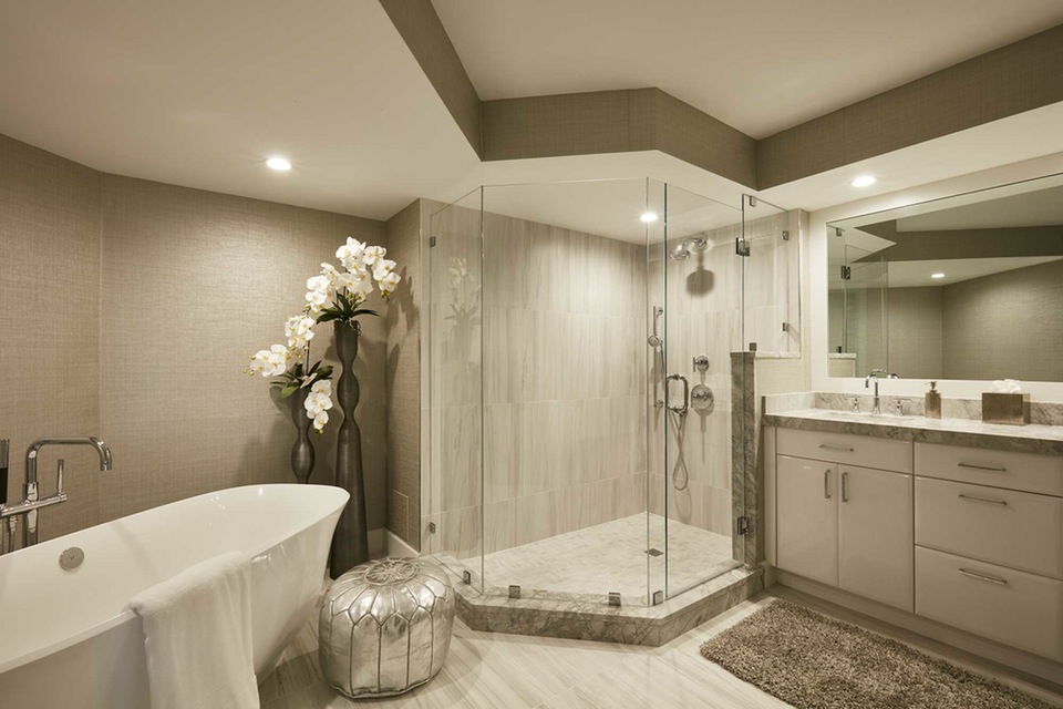 Bathroom with white tub and glass shower.