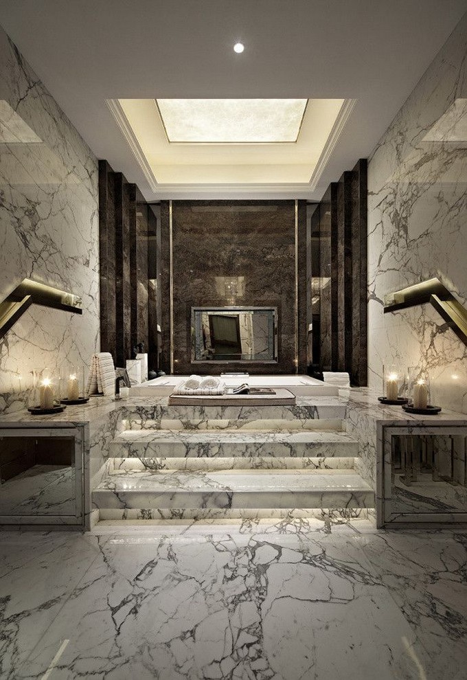 Large bathroom with marble floor and walls, flanked by dark walls.