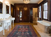 A spacious bathroom with a plush rug and a white bathtub, featuring wood accents.