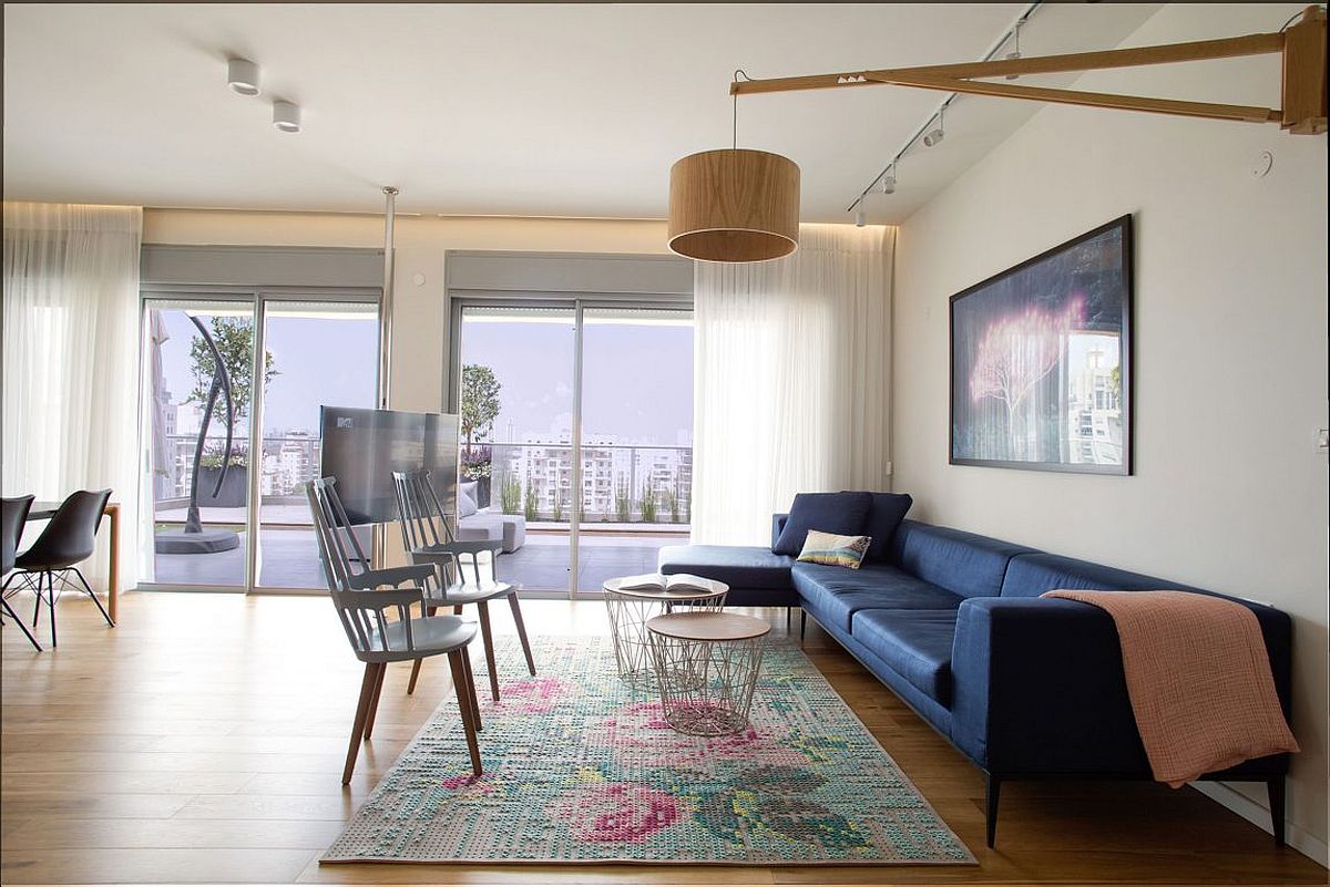 Open living space of the Israeli penthouse connected with the large balcony outside