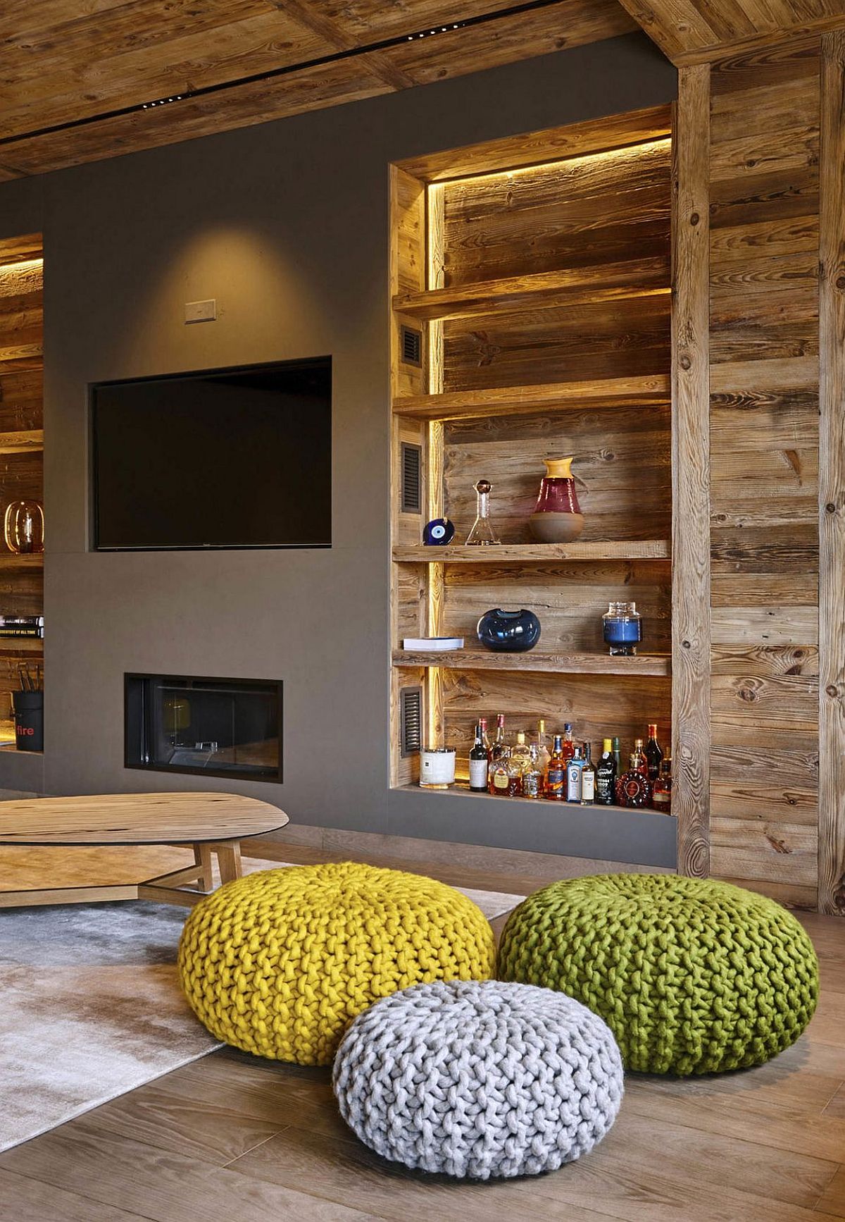 Open wooden shelves next to the TV wall in gray with fireplace below