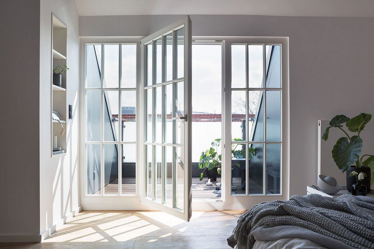 Penthouse bedroom in gray and white connected with the small balcony