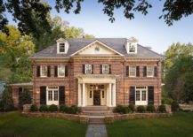 Red brick home with white columns and dormer windows