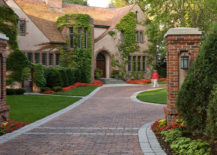 Red brick house with matching brick driveway.