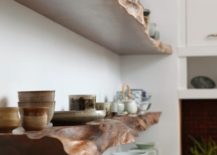 Rustic wooden floating shelves used to hold dish-ware.
