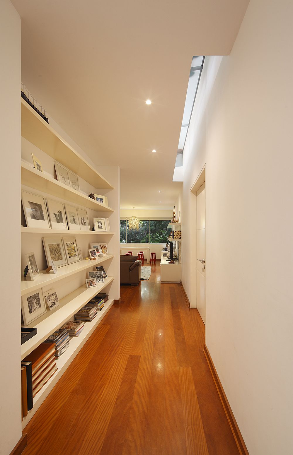 Skylight brings ventilation into the corridor with bookshelf