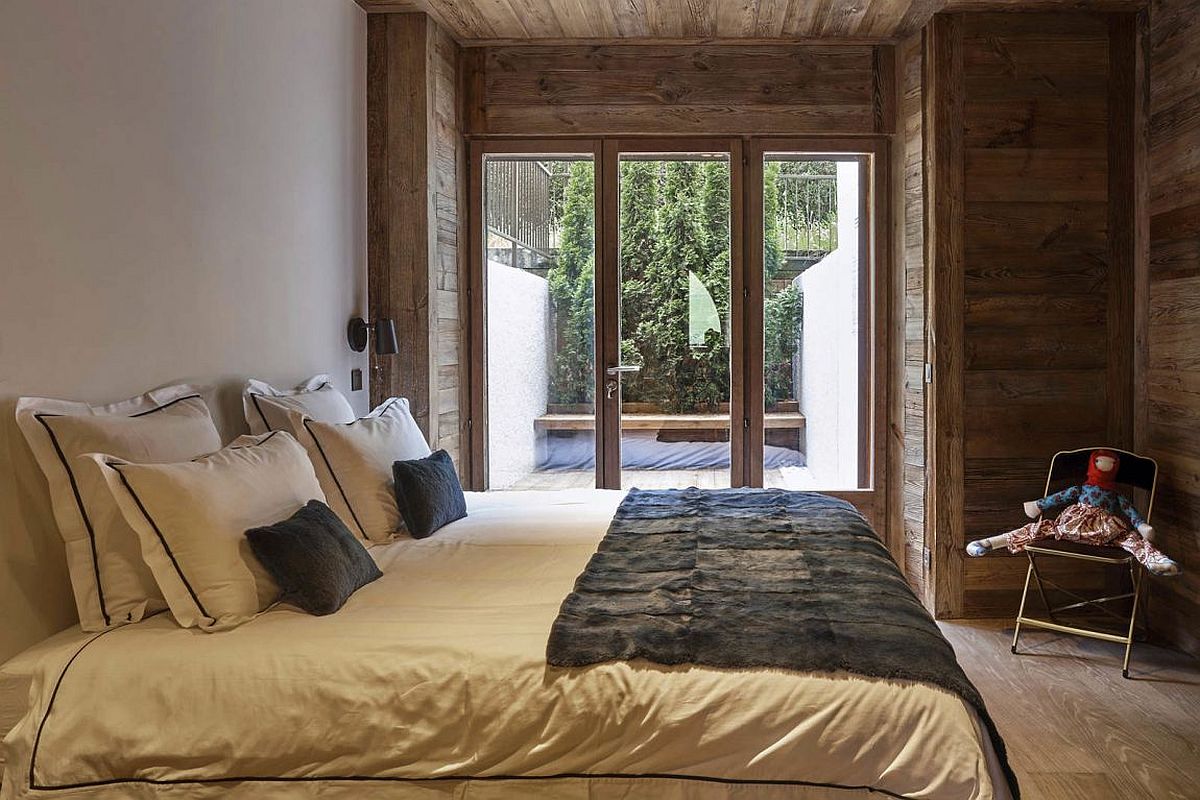 Small-bedroom-of-the-revamped-French-home-connected-with-the-balcony-outside