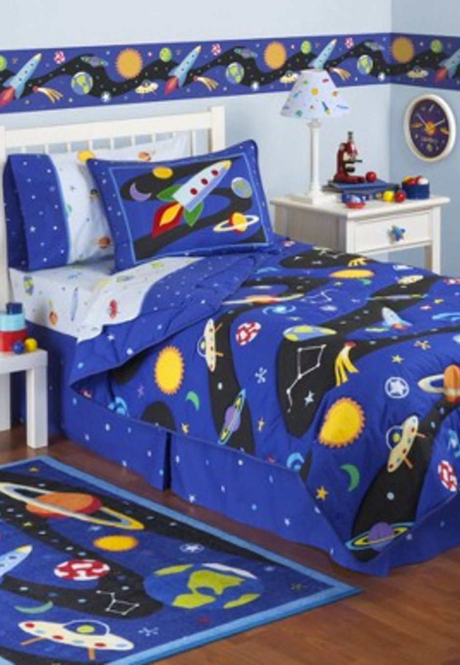 Space children's room with rocket-themed carpet, strip wallpaper, and bedding.