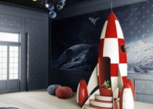A space-themed bedroom with a rocket, star-themed ceiling, and outer space on the walls.