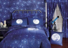Space children's room with moon-themed comforter and a blue telescope.