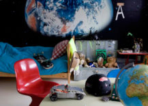 Space children's room with educational props flanked by a painting of Earth.