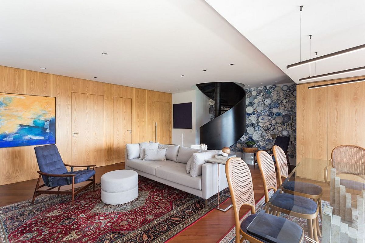 Spiral staircase and an accent wall become the focus of the gorgeous living area