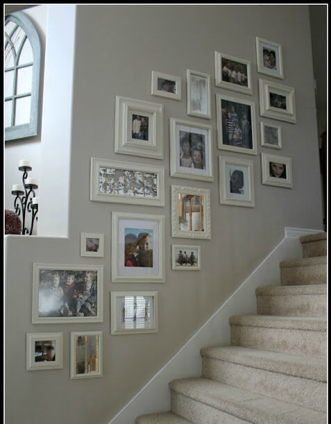 Family picture gallery in a stairway that has carpeted steps.