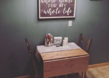 A cozy setup with a small table and two chairs is captured in the image. A sign that reads 'you love my whole life' is placed on the table, adding a romantic touch to the scene.