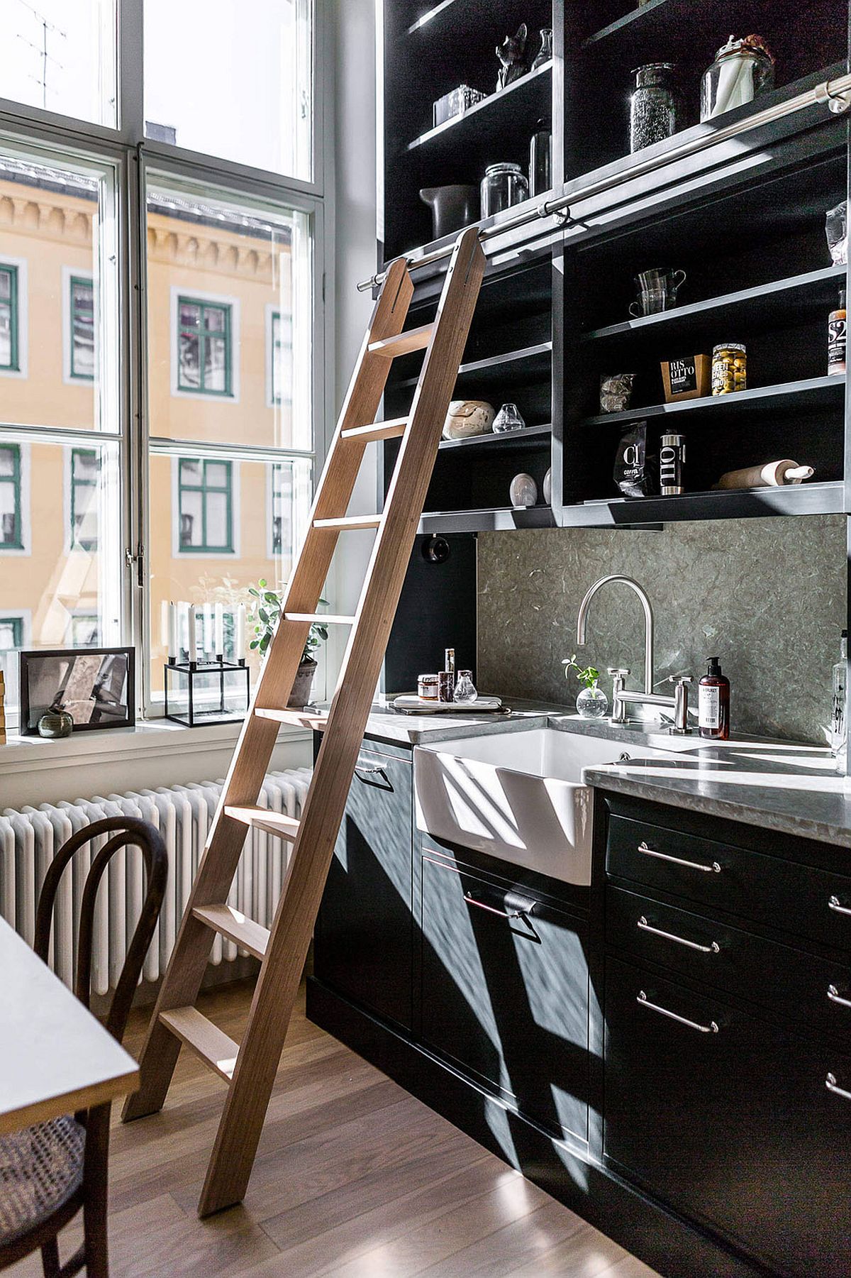 Tall cabinets and shelves make use of the vertical space in the kitchen