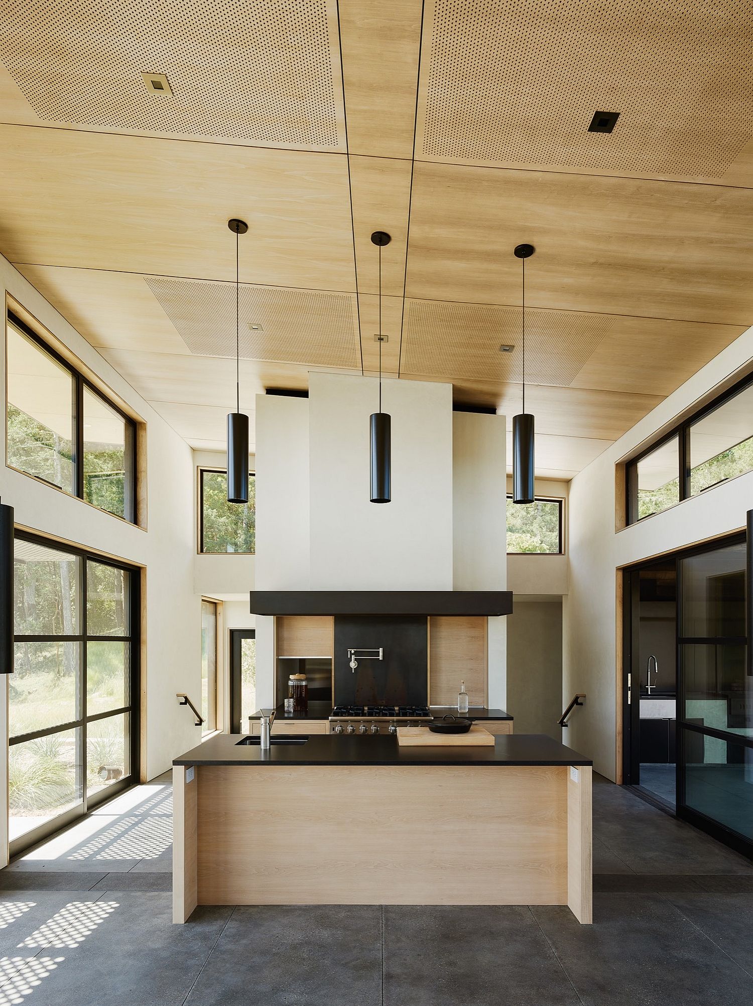Trio of pendants adds to the charm of the kitchen with high ceiling
