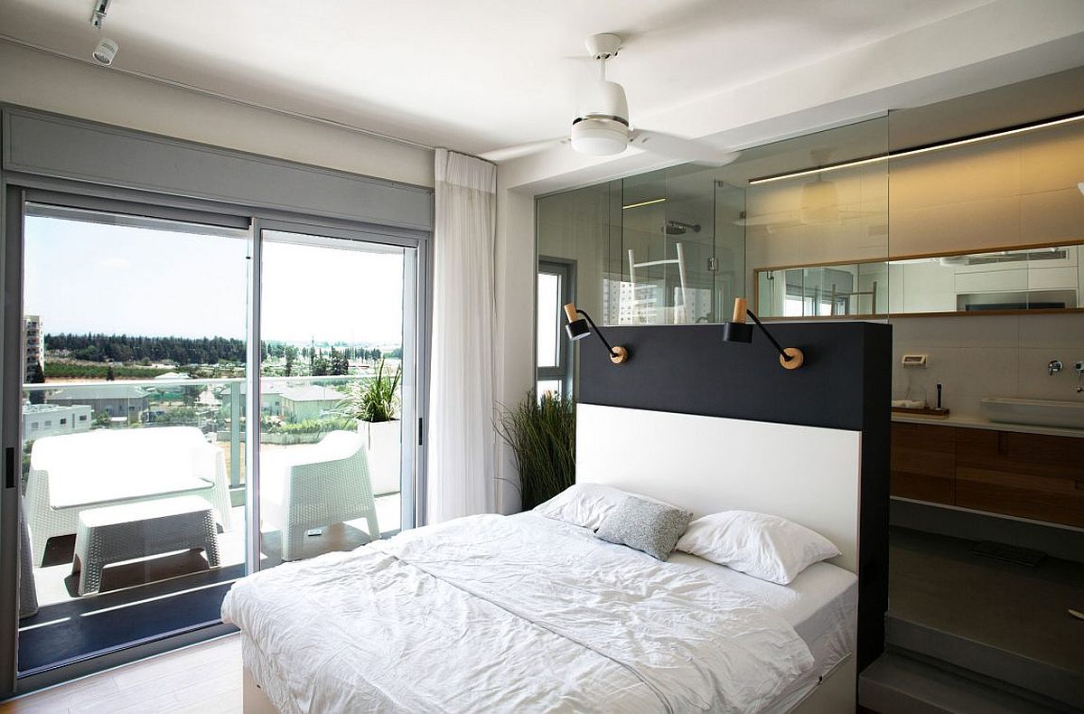 Unique placement of bed gives access to the balcony and the city skyline view outside