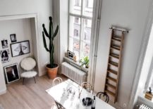 View-of-the-small-light-filled-dining-area-of-the-Scandinavian-style-apartment-with-a-ladder-217x155