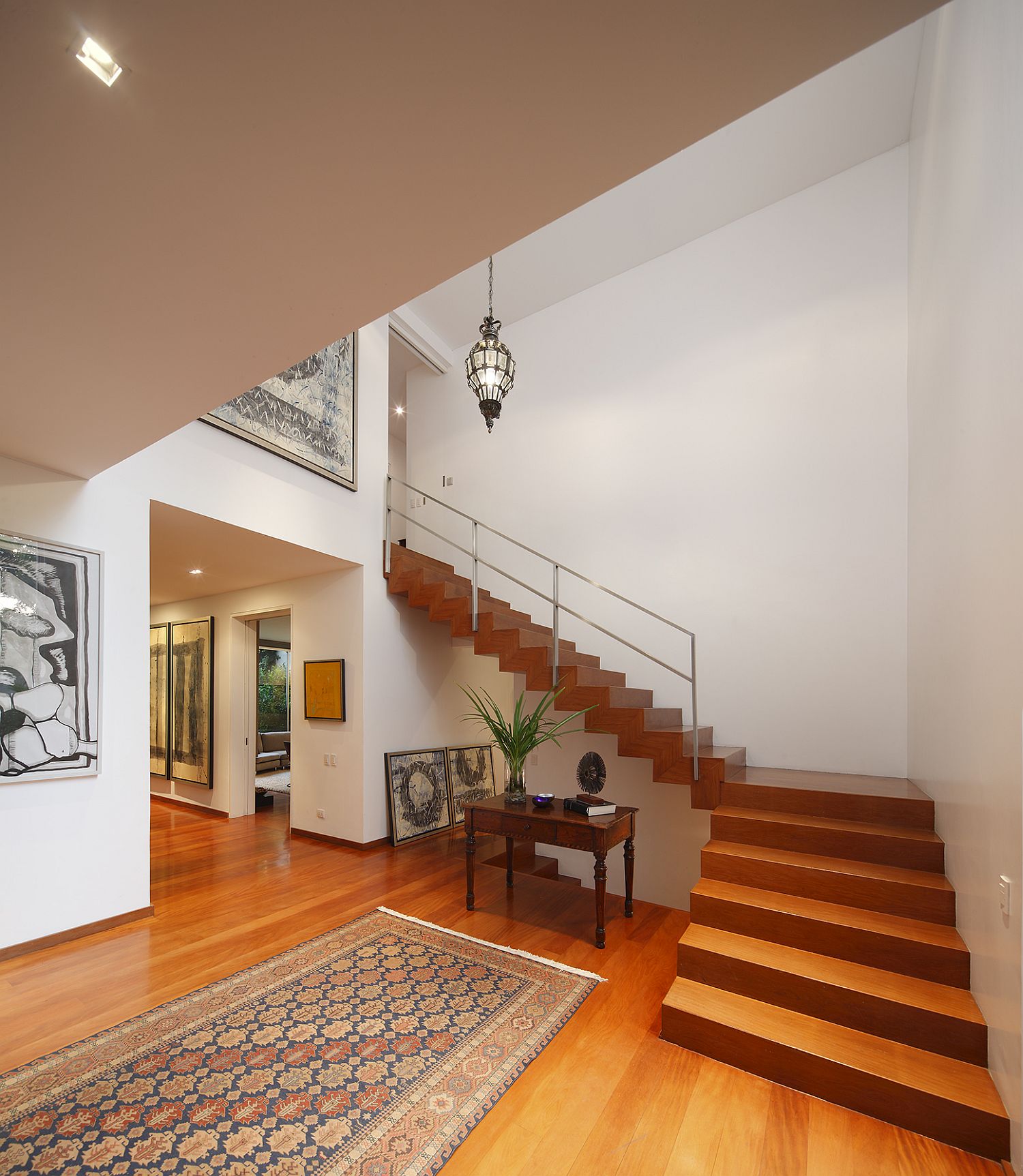 Wooden staircase connects the lower level with the top floor