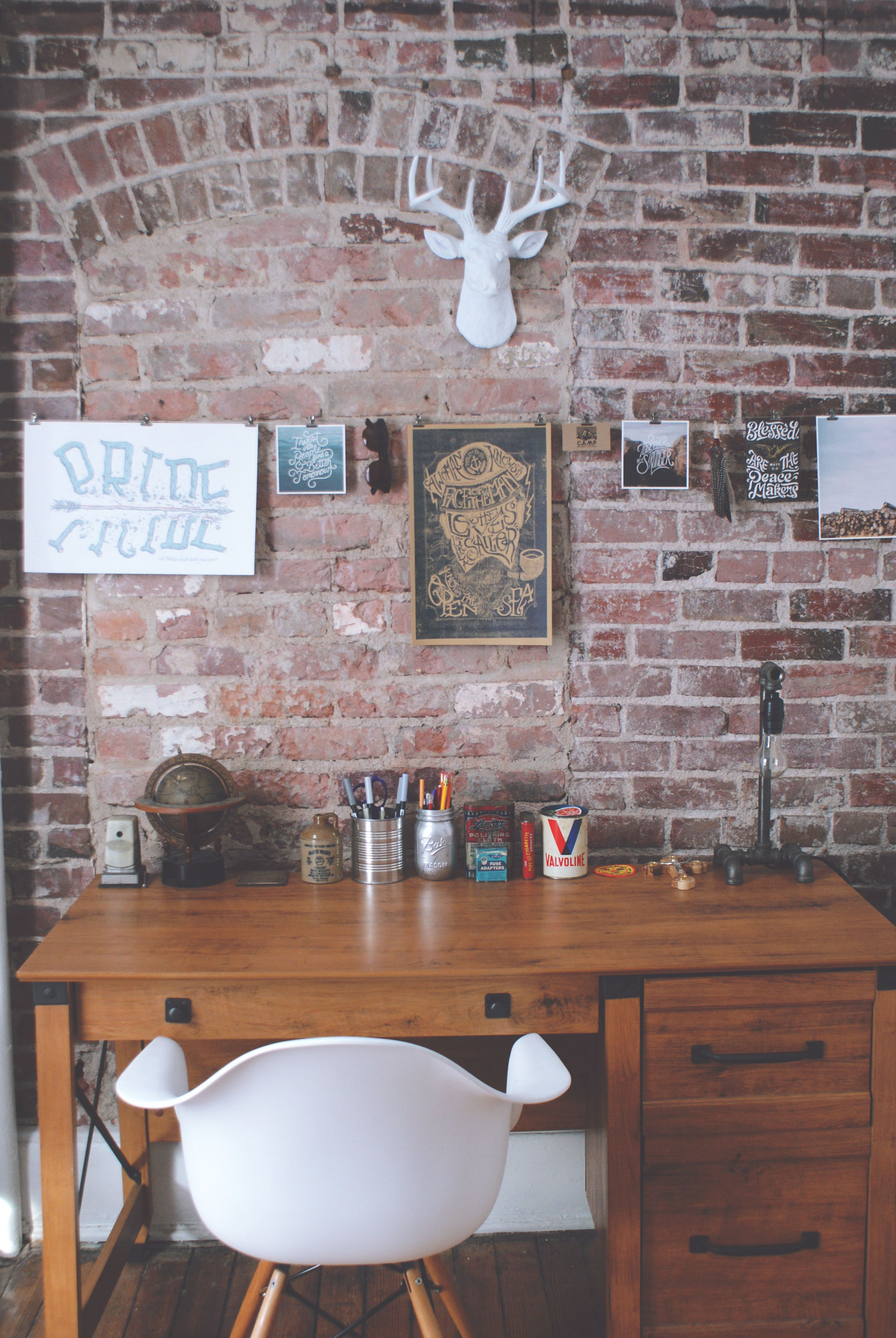 A home office with an exposed brick and rustic interior