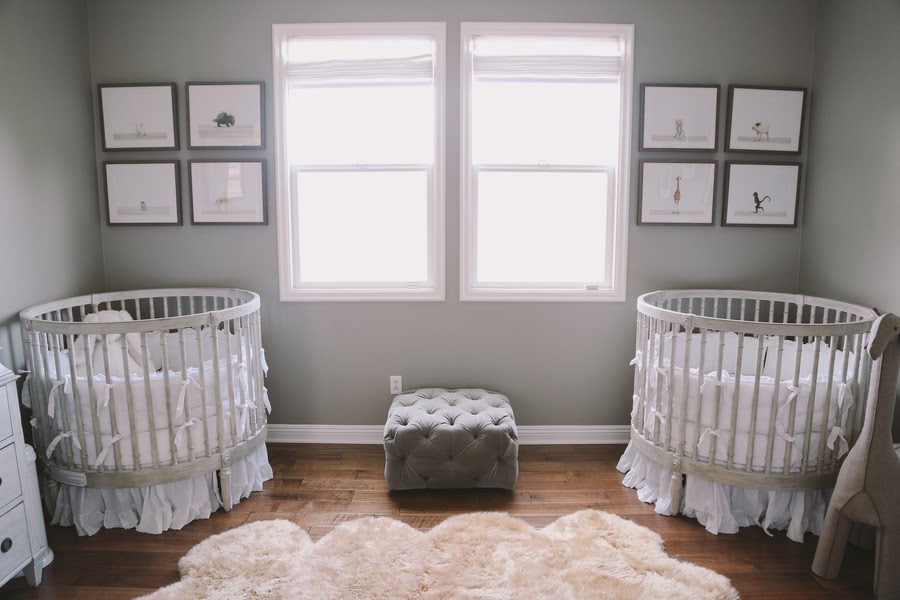 A-lovely-gray-nursery-with-round-cribs