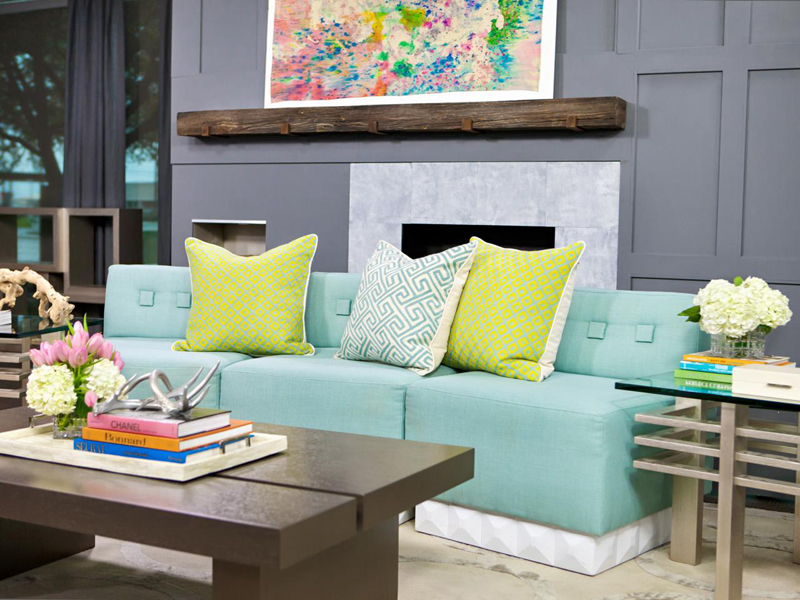 A mint sofa as the focal point in a neutral wooden living room