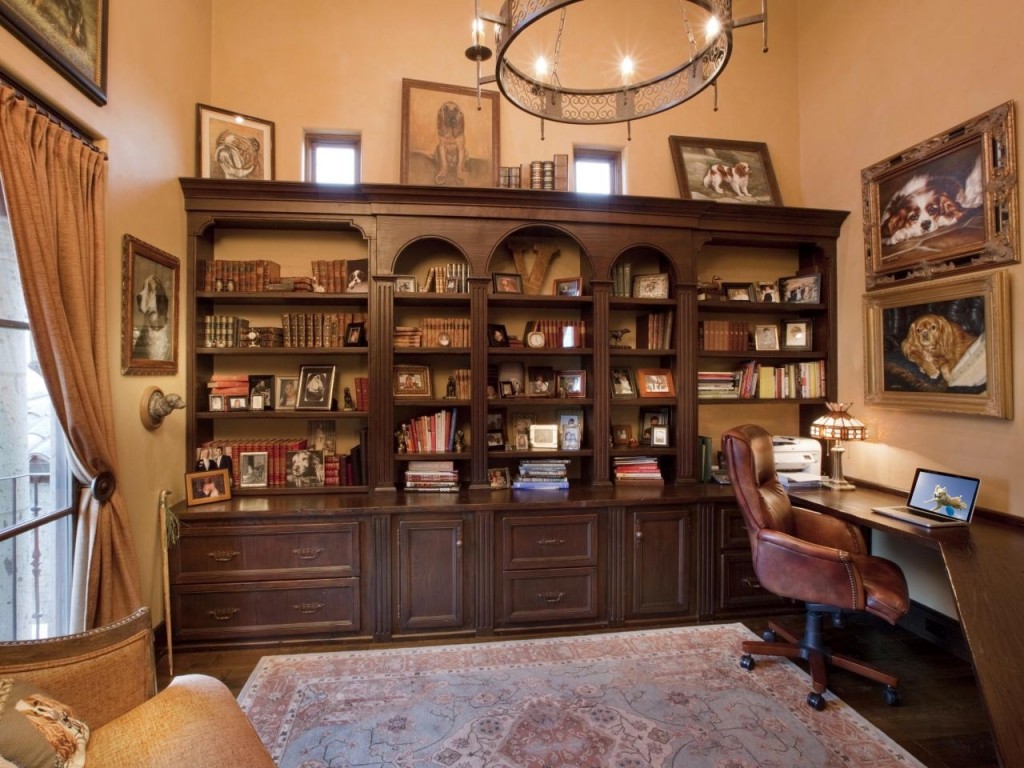 A spacious rustic home office with a smaller desk