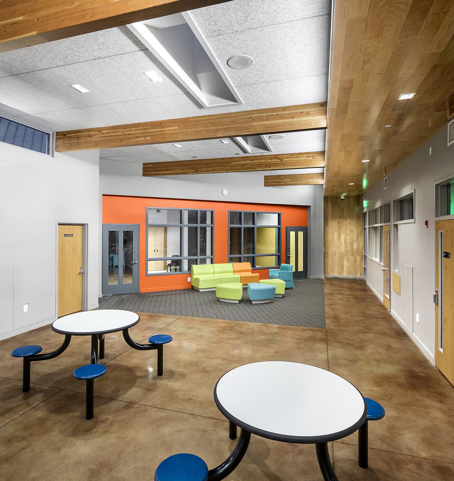 Accent wall in orange brings brightness to the versatile interior