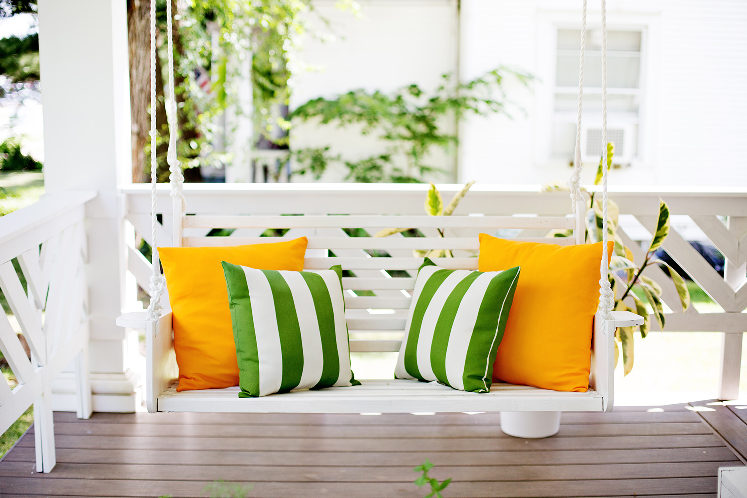 Almost-hidden-bright-white-swing-with-noticable-pillows