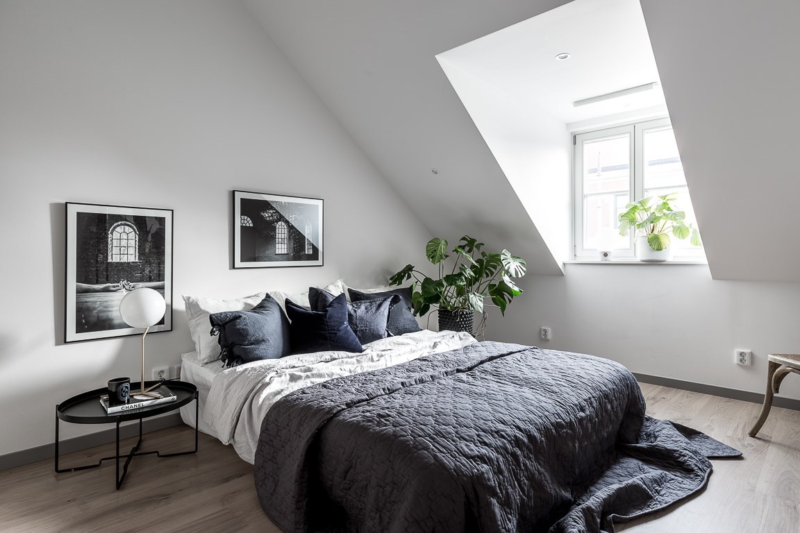 An attic bedroom in calming, neutral tones