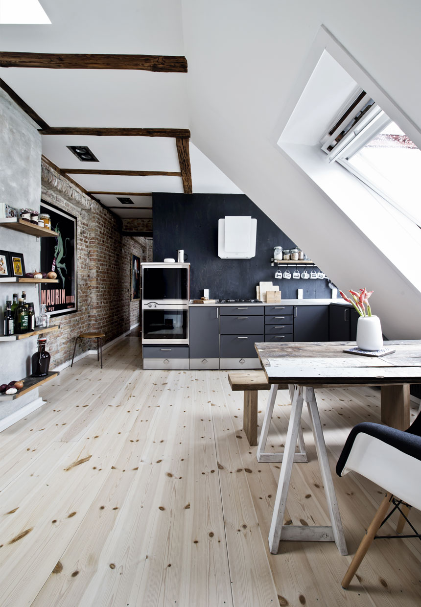 Attic kitchen combining wood, brick and black interior