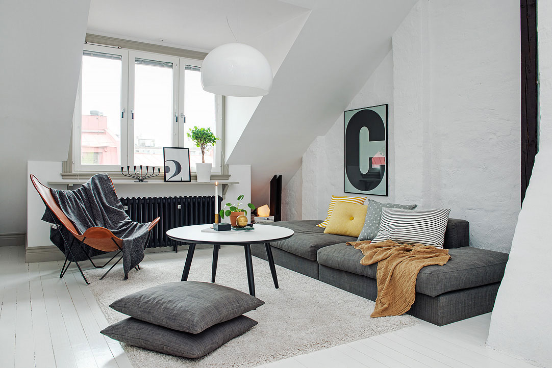 Attic living room with neutral tones and natural light