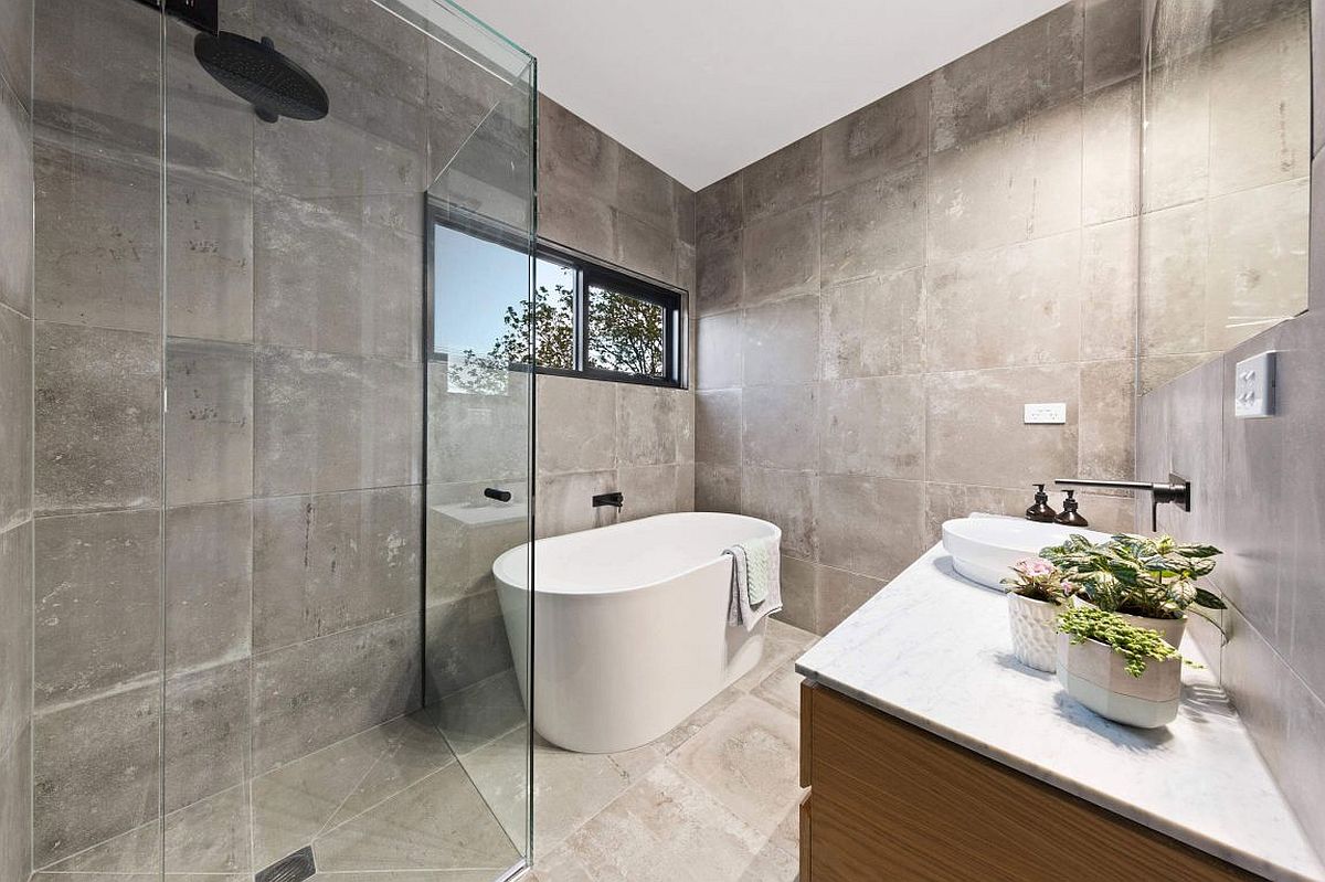 Bathtub in white in the corner is a space-saver in the contemporary bathroom