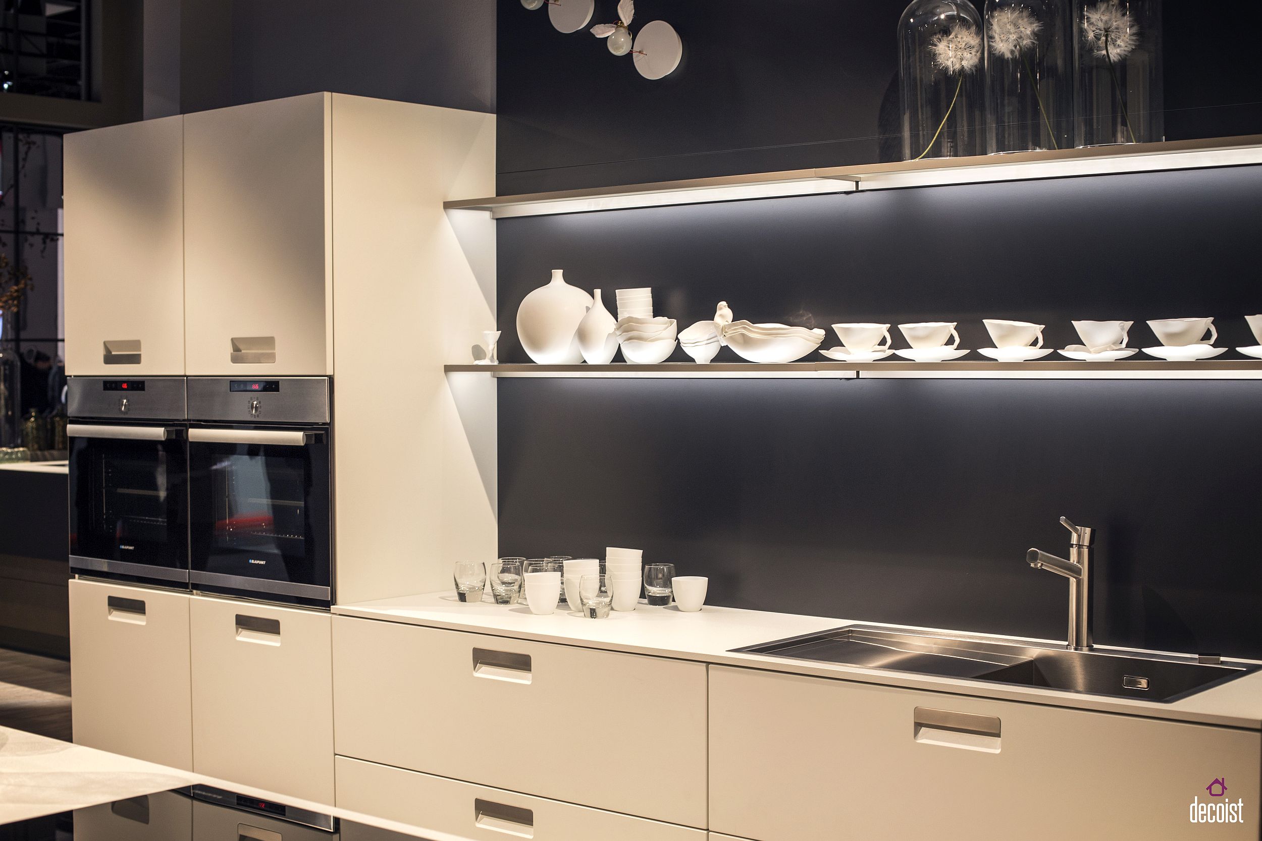 Beautifully lit floating open shelves are perfect for the small contemporary kitchen